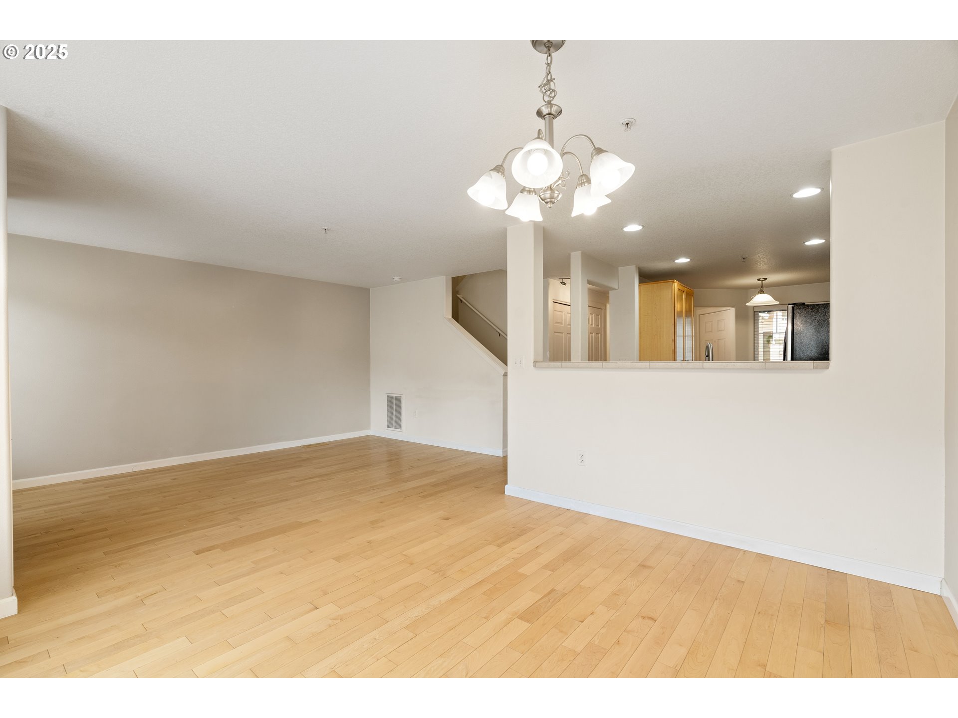 10723 Southwest Canterbury Lane, Unit 102 Portland, OR 97224 - Photo 15 of 30 a view of an empty room and chandelier fan