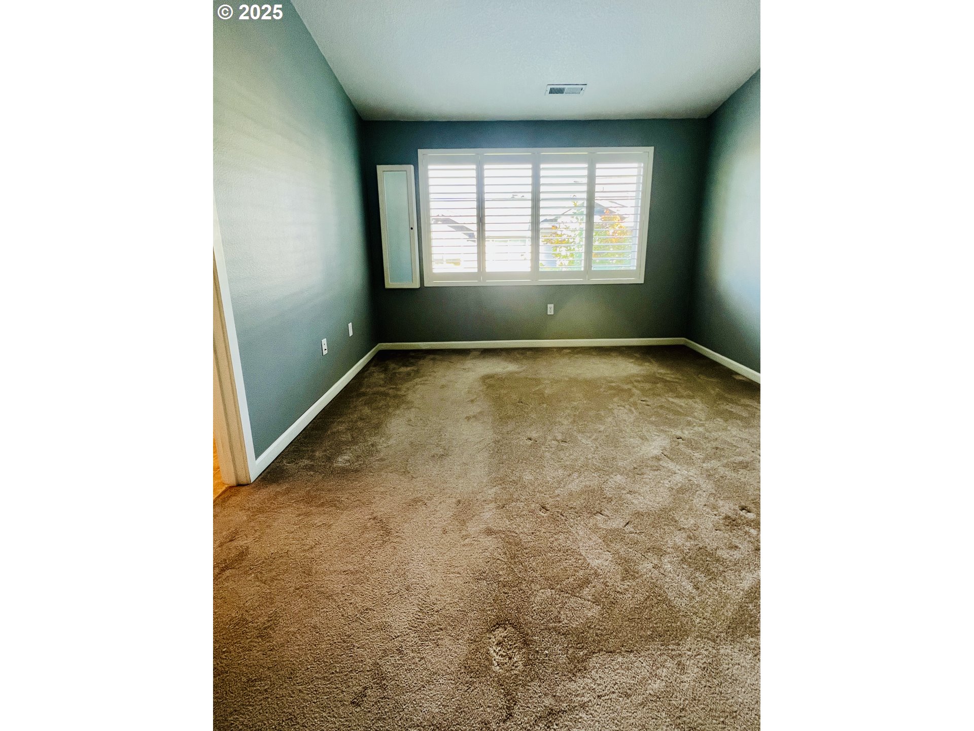 10723 Southwest Canterbury Lane, Unit 102 Portland, OR 97224 - Photo 19 of 30 a view of an empty room with a window
