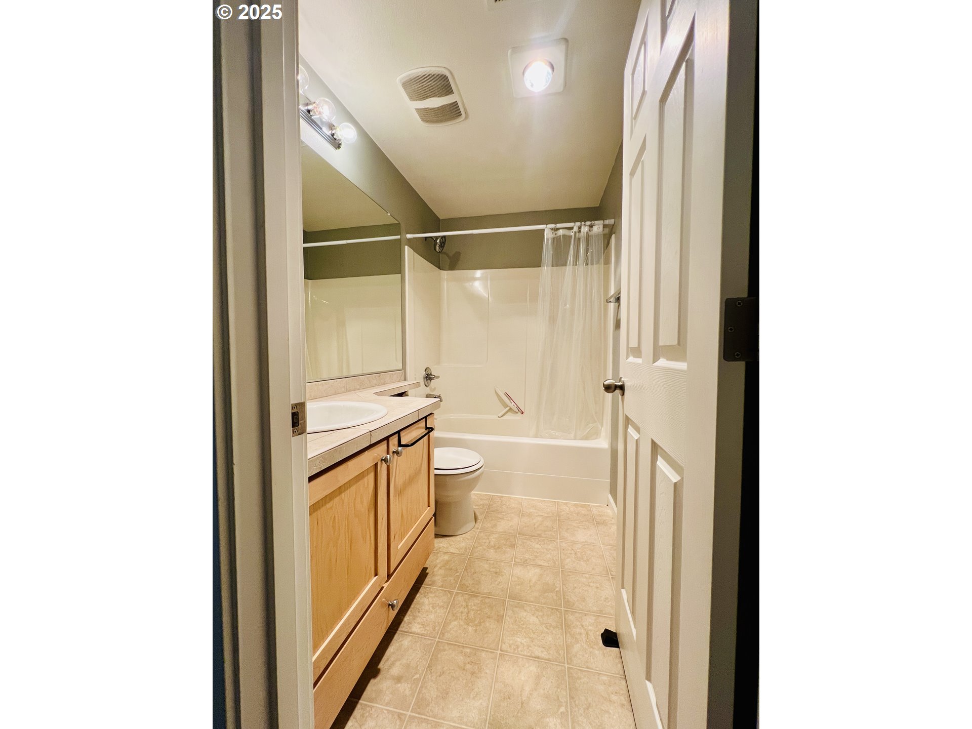 10723 Southwest Canterbury Lane, Unit 102 Portland, OR 97224 - Photo 24 of 30 a bathroom with a shower and a sink