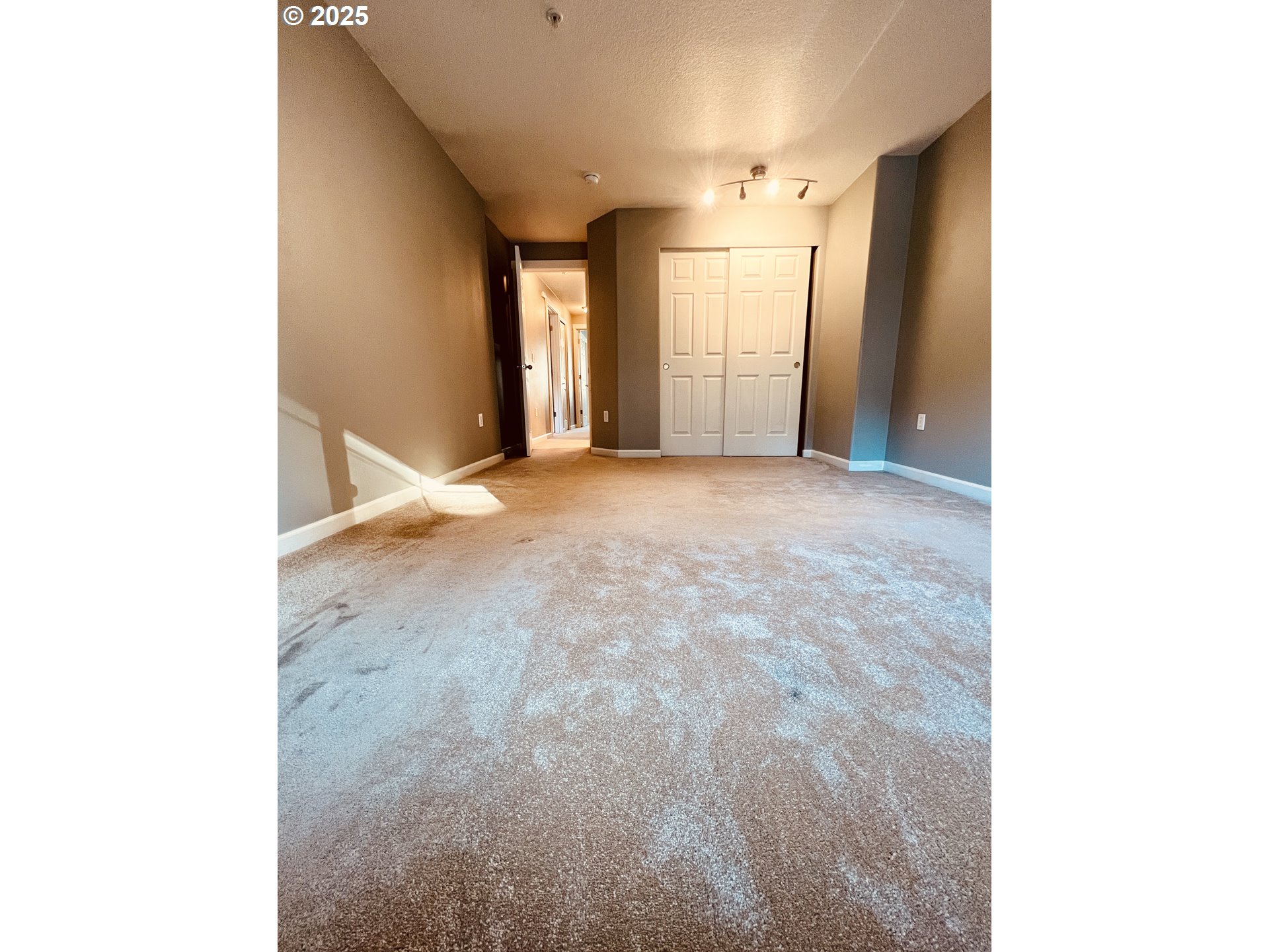 10723 Southwest Canterbury Lane, Unit 102 Portland, OR 97224 - Photo 27 of 30 a view of an empty room with window