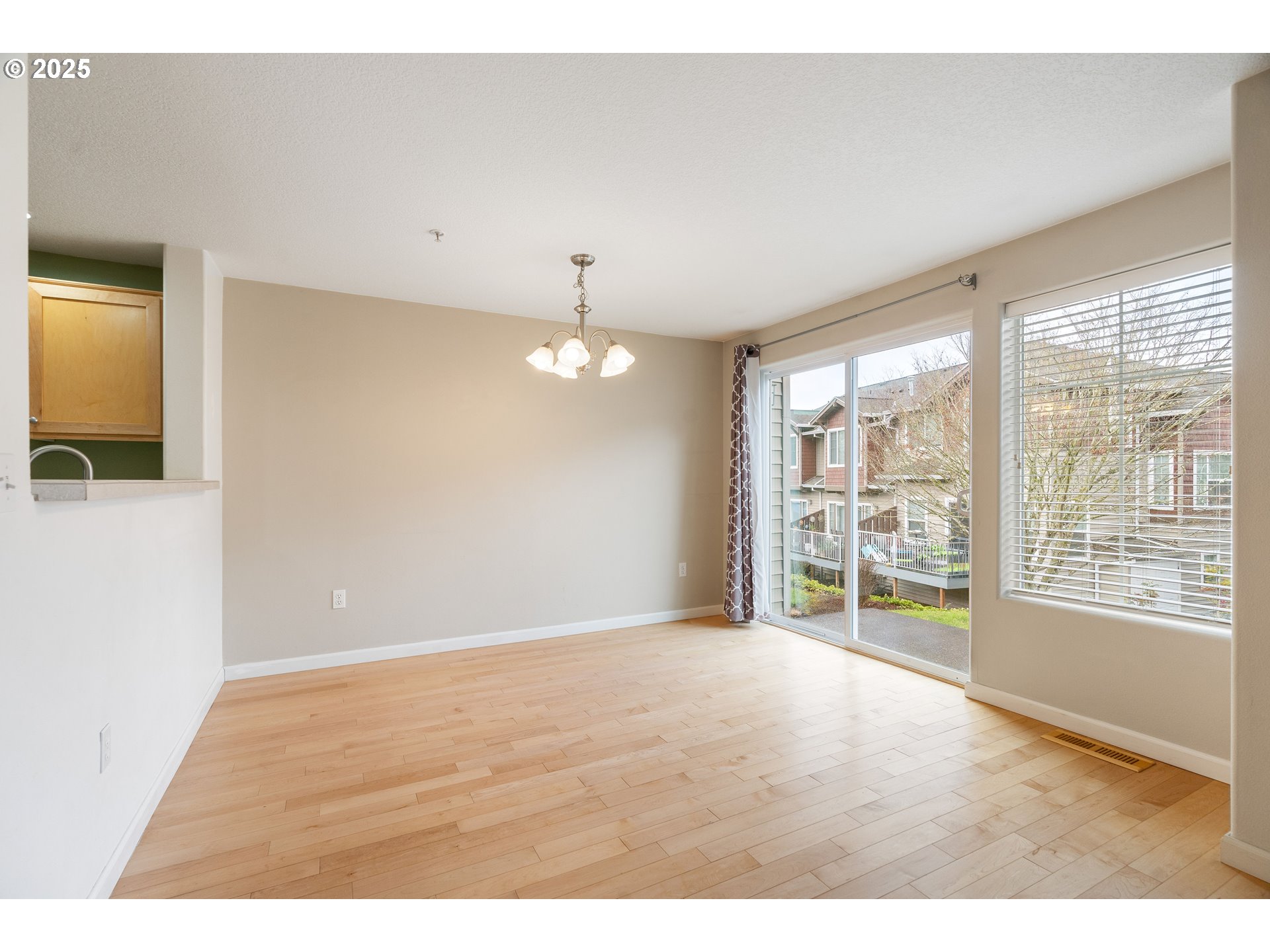 10723 Southwest Canterbury Lane, Unit 102 Portland, OR 97224 - Photo 7 of 30 a view of an empty room with a window