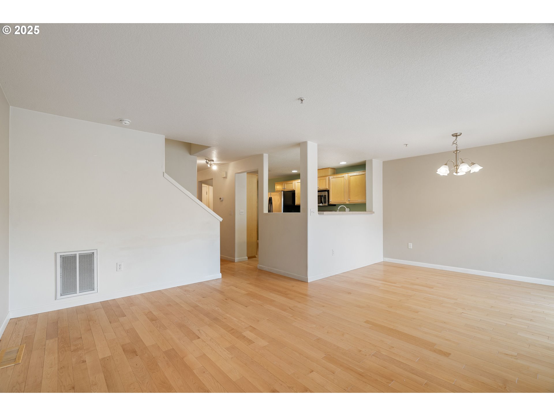 10723 Southwest Canterbury Lane, Unit 102 Portland, OR 97224 - Photo 8 of 30 a view of a big room with wooden floor and windows