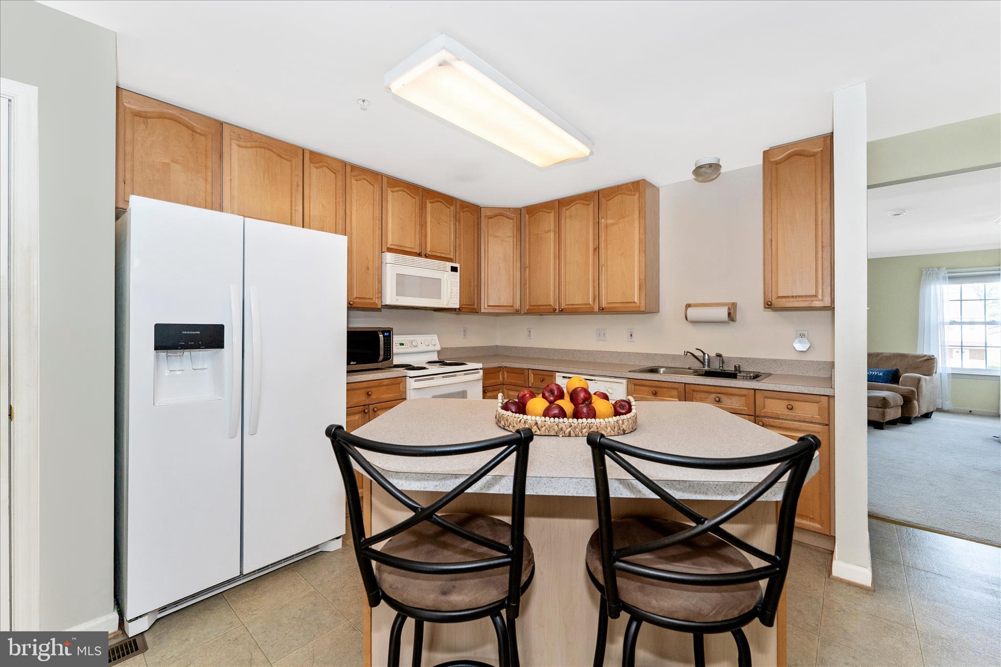 123 Jason's Ridge Smithsburg, MD 21783 - Photo 12 of 57 a kitchen with stainless steel appliances a dining table chairs and wooden cabinets