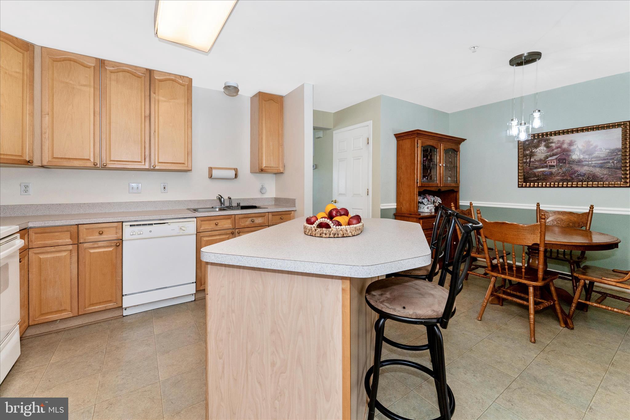 123 Jason's Ridge Smithsburg, MD 21783 - Photo 13 of 57 a kitchen with stainless steel appliances kitchen island granite countertop a table chairs sink and cabinets