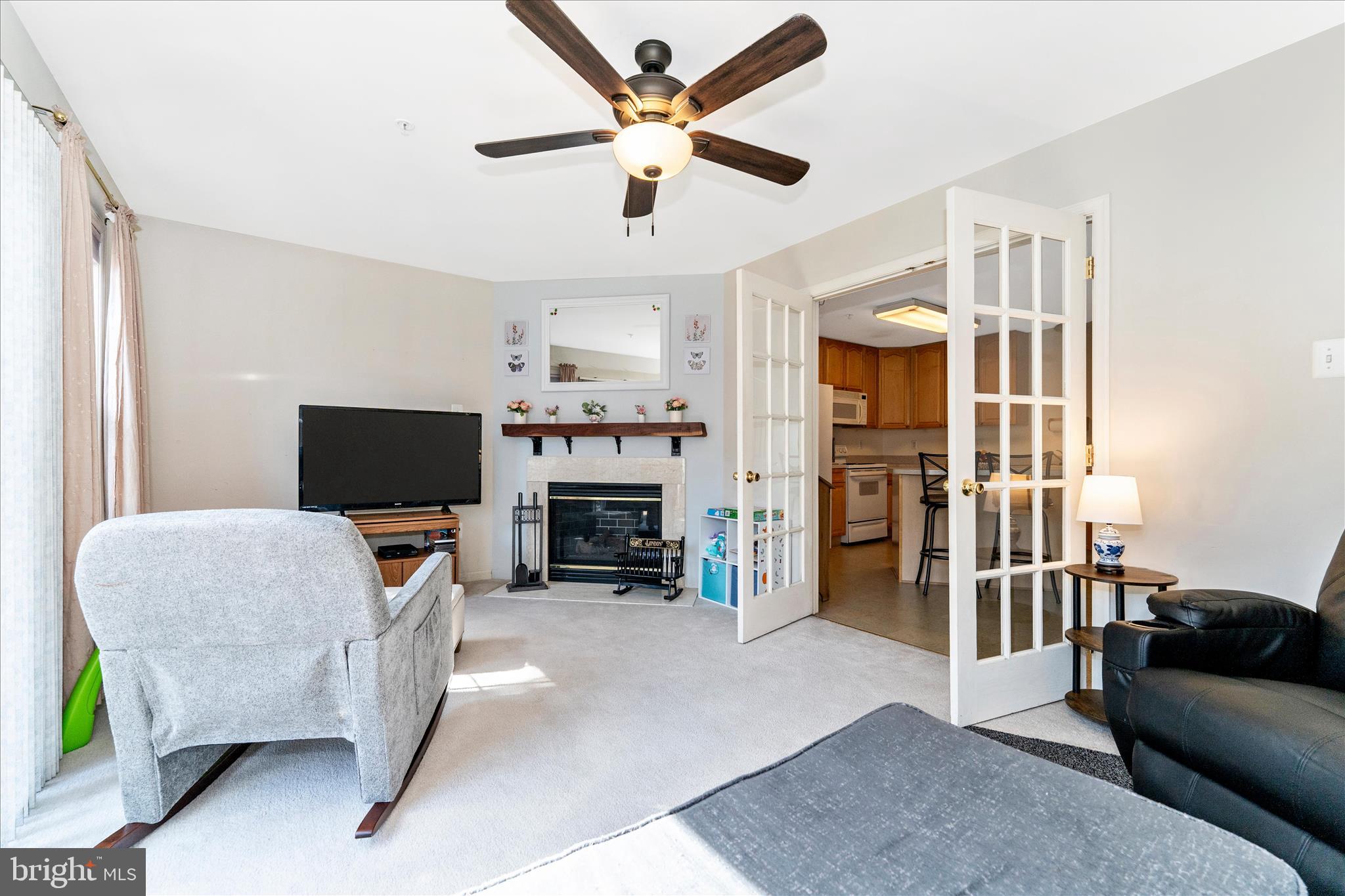 123 Jason's Ridge Smithsburg, MD 21783 - Photo 21 of 57 a living room with furniture a fireplace and a flat screen tv
