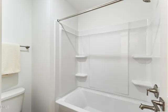 a bathroom with a bathtub and toilet