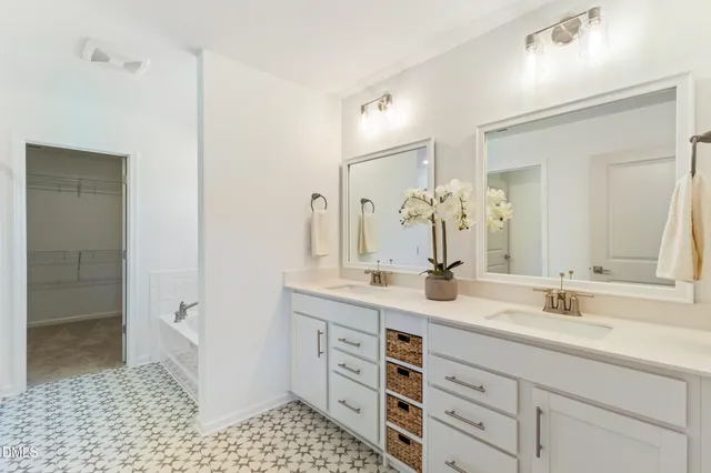 a bathroom with a double vanity sink mirror and shower