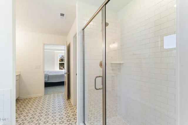 a bathroom with a glass shower door