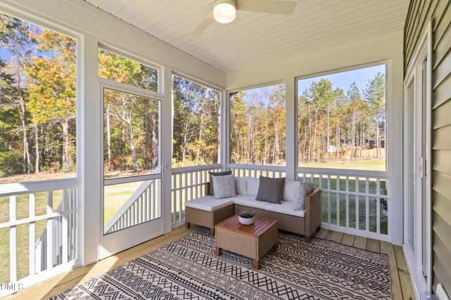 a living room with furniture and a window with outer view