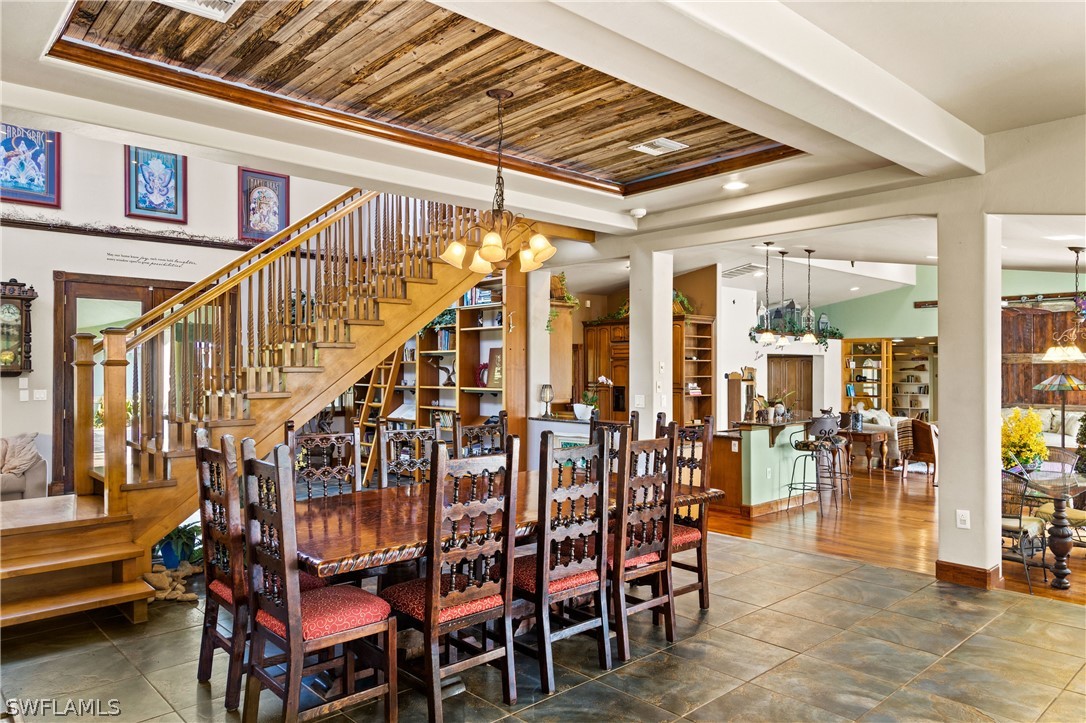17700 Caloosa Road Alva, FL 33920 - Photo 9 of 35 a dining room with lots of wooden furniture and a chandelier