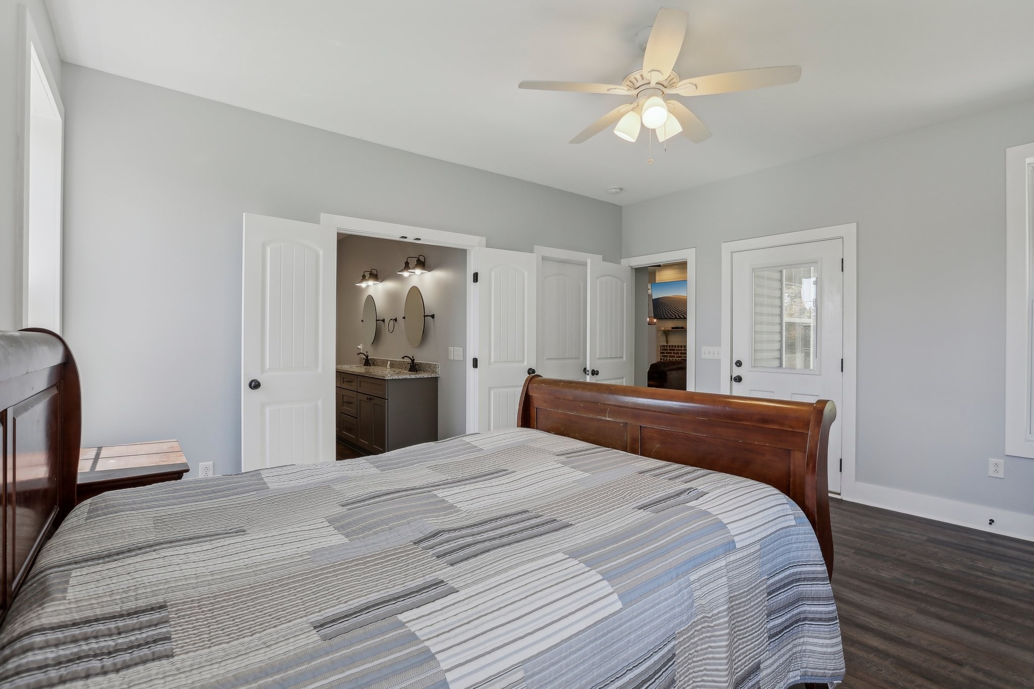 521 Boiling Springs Road Portland, TN 37148 - Photo 30 of 61 a bedroom with a large bed and a chandelier