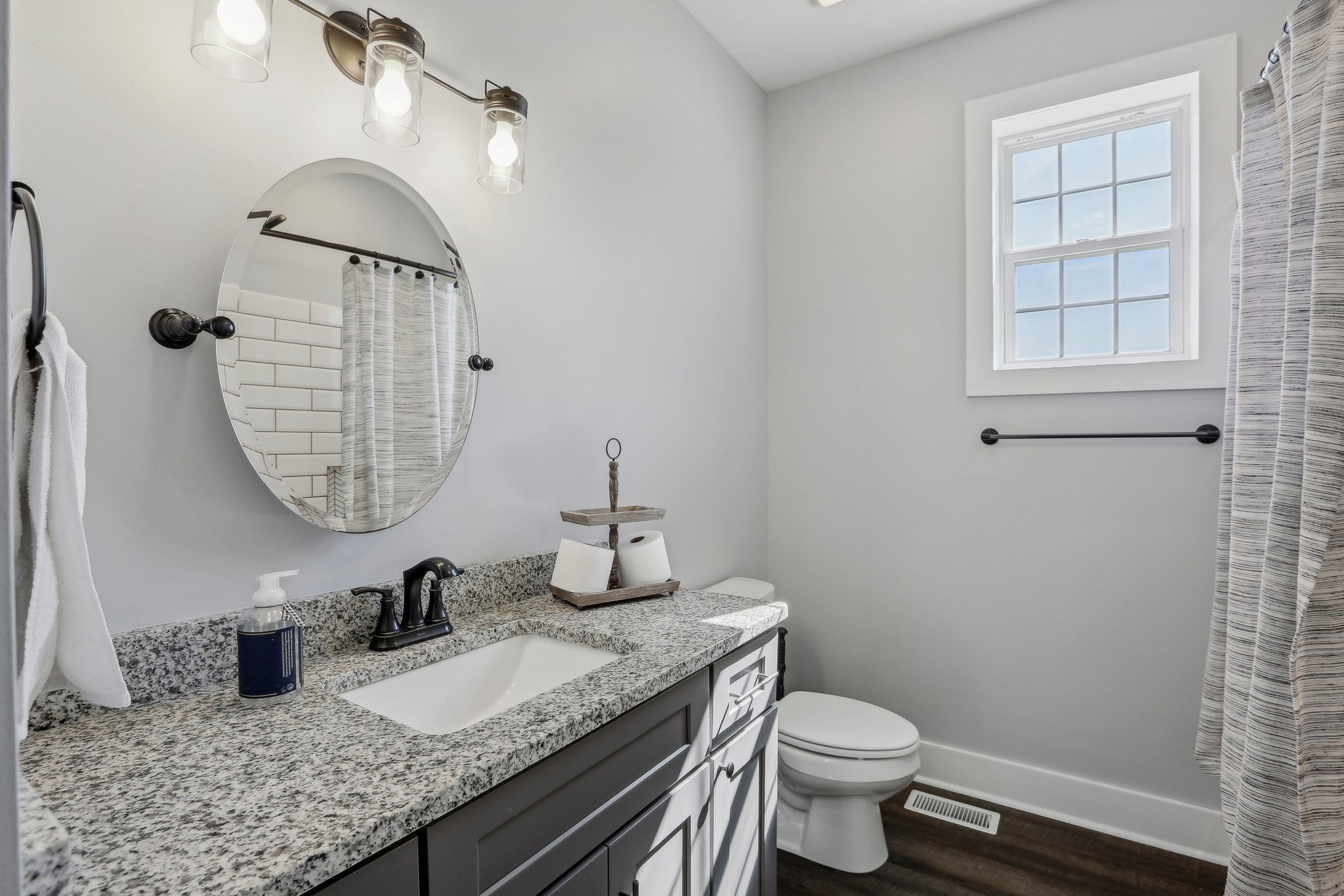 521 Boiling Springs Road Portland, TN 37148 - Photo 38 of 61 a bathroom with a granite countertop toilet sink and mirror