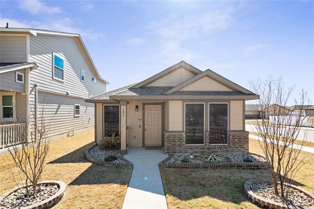 301 Cane River Road Pflugerville, TX 78660 - Photo 1 of 1 a front view of a house with garden