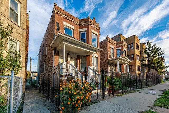 a front view of a multi story residential apartment building with a yard