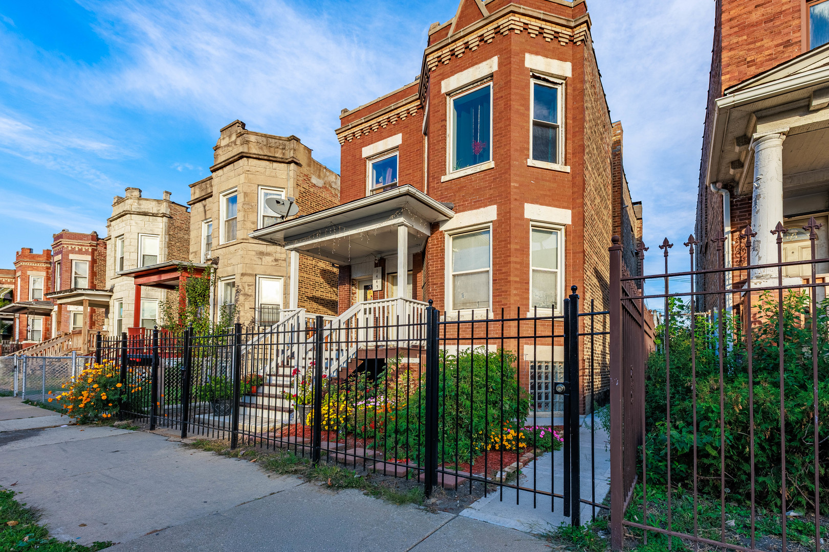 1445 South Kostner Avenue, Unit 1 Chicago, IL 60623 - Photo 15 of 15 front view of a brick house with a small yard