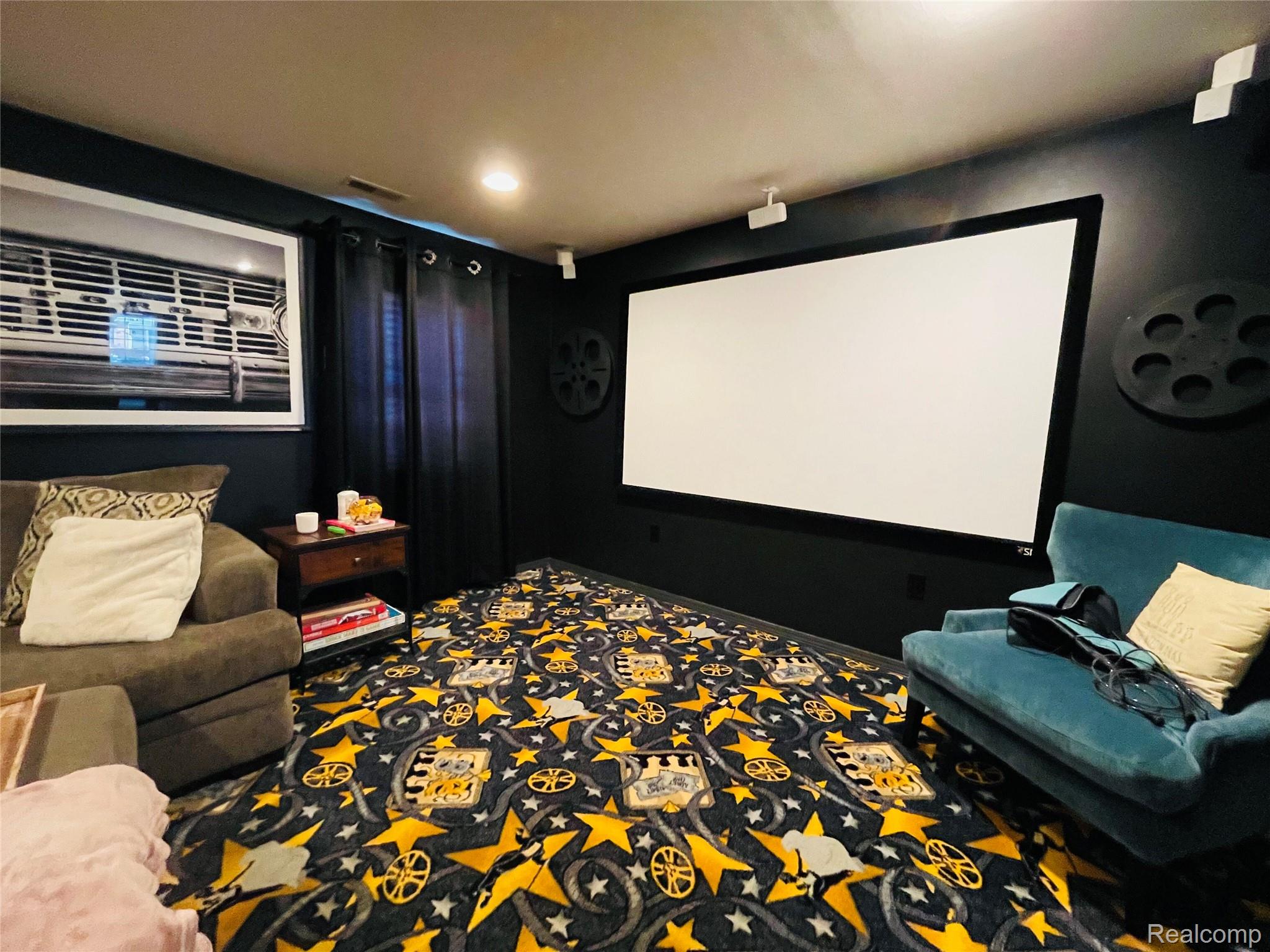 488 Welch Road Northville, MI 48167 - Photo 7 of 22 Dedicated media room featuring a large projection screen and dark wall colors