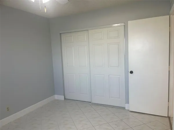 an empty room with closet area