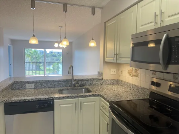 a kitchen with a sink and a microwave