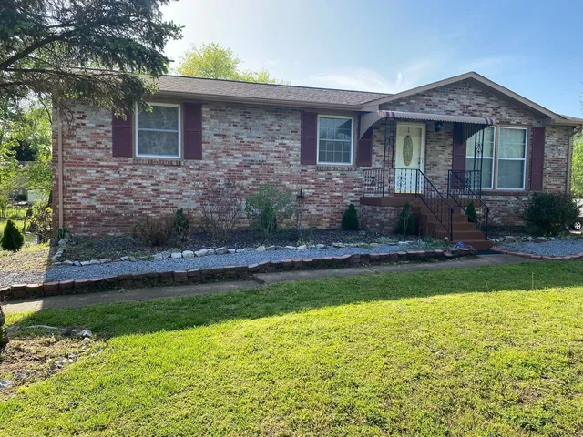 a front view of a house with a yard table and chairs