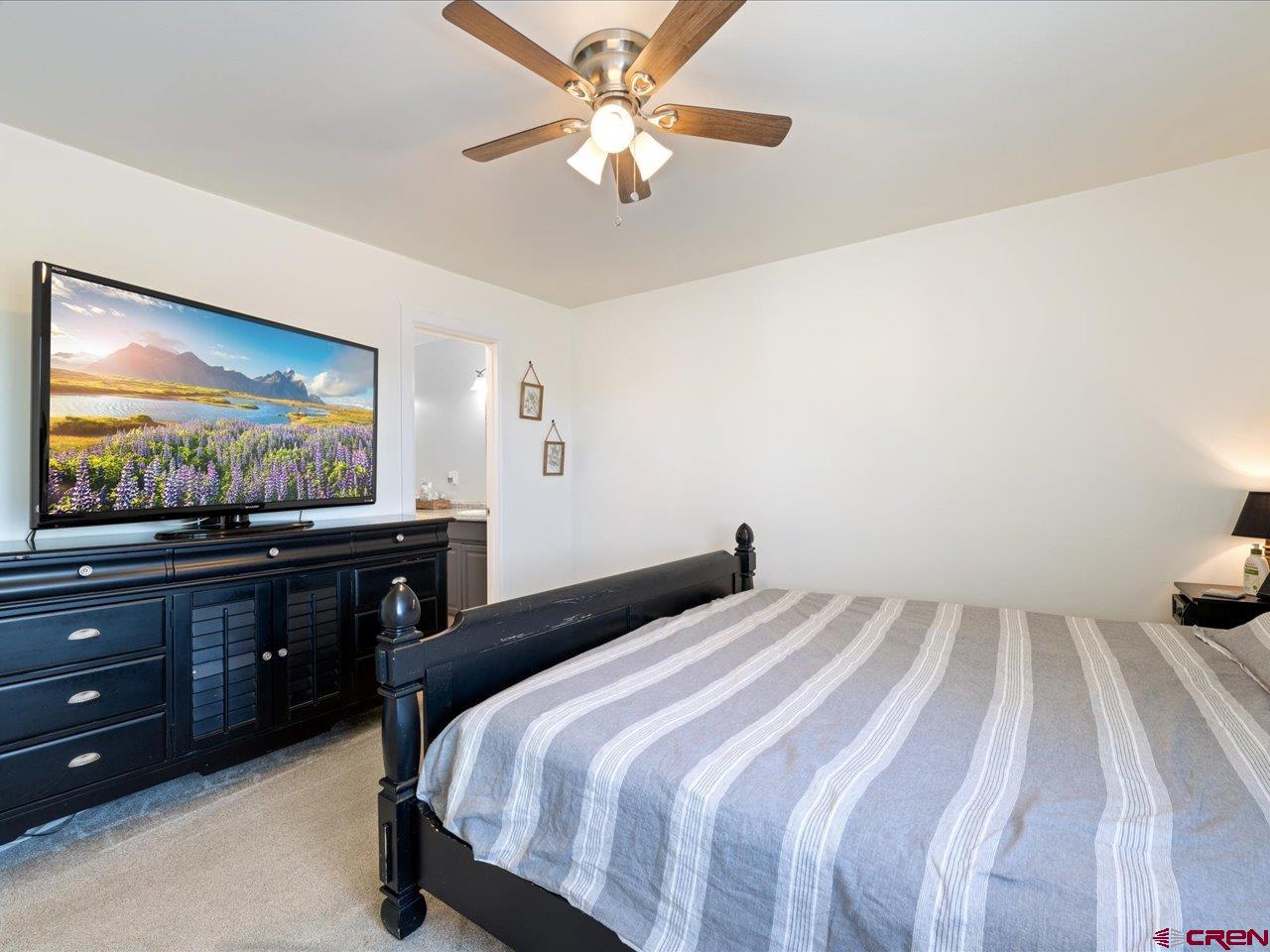 3580 Ruth Lane Delta, CO 81416 - Photo 18 of 35 a bedroom with a bed and a flat screen tv