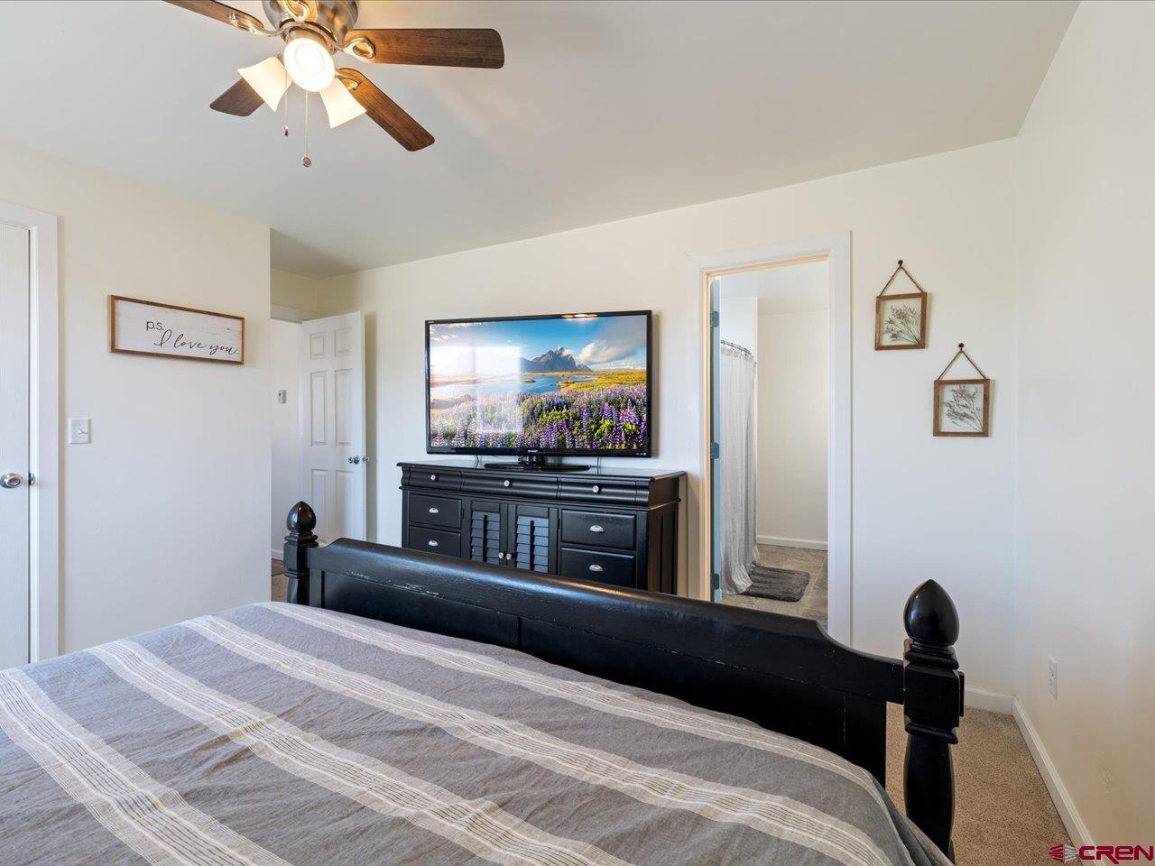 3580 Ruth Lane Delta, CO 81416 - Photo 19 of 35 a bedroom with a bed and a flat screen tv