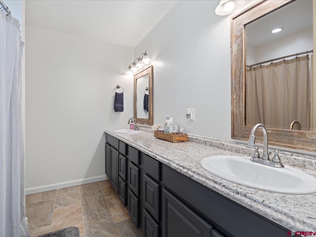 3580 Ruth Lane Delta, CO 81416 - Photo 20 of 35 a bathroom with double sink and a mirror