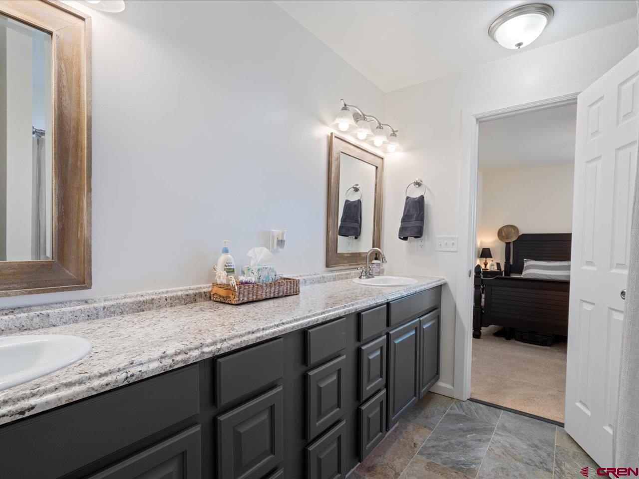 3580 Ruth Lane Delta, CO 81416 - Photo 25 of 35 a bathroom with a granite countertop double vanity sink and a mirror