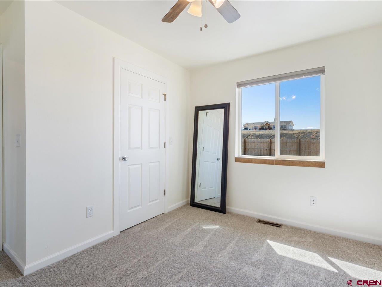 3580 Ruth Lane Delta, CO 81416 - Photo 26 of 35 an empty room with a window and a ceiling fan