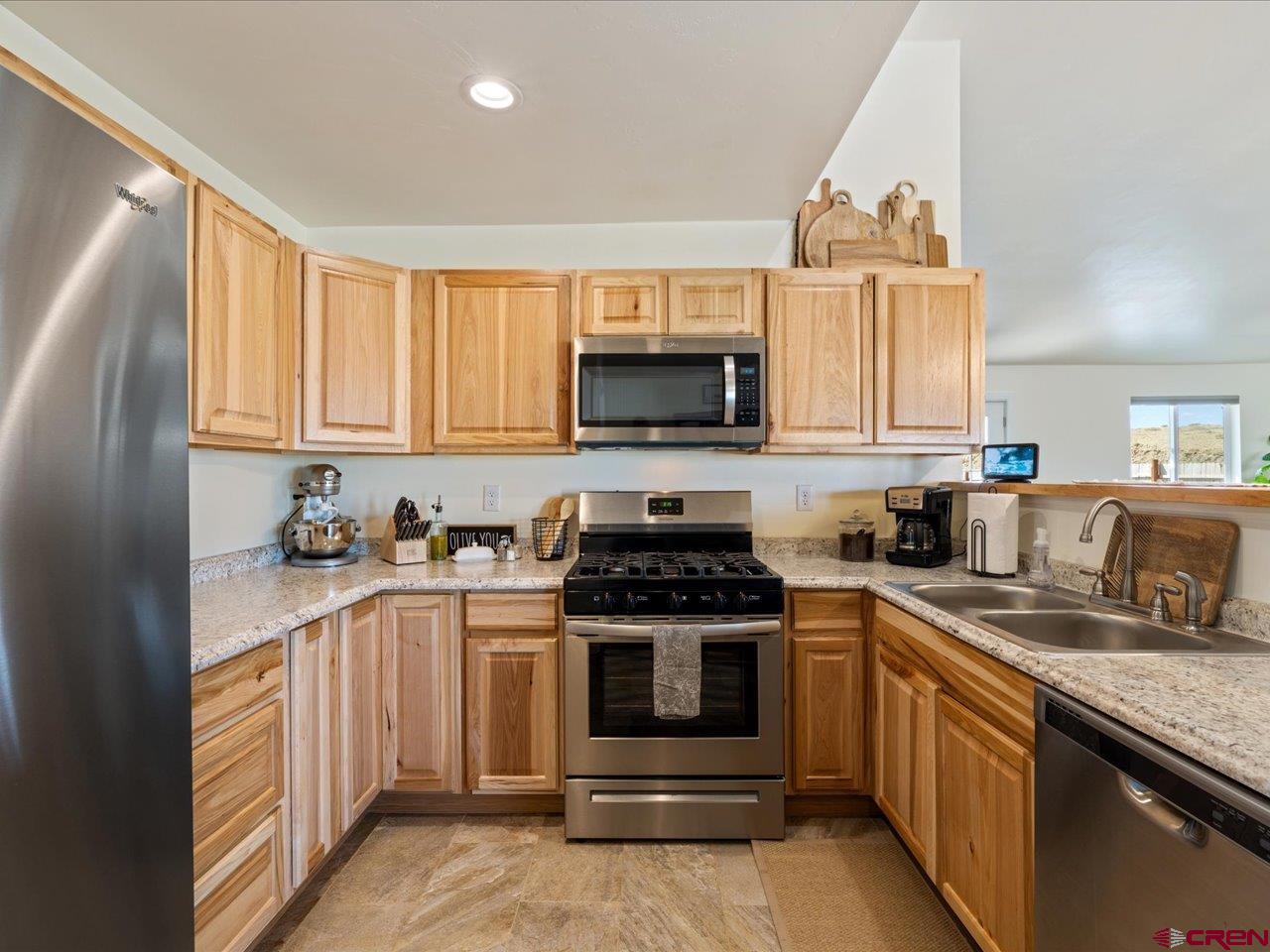 3580 Ruth Lane Delta, CO 81416 - Photo 9 of 35 a kitchen with stainless steel appliances granite countertop a stove a sink and a microwave