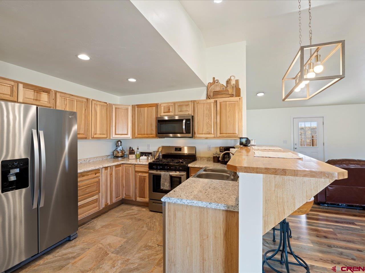 3580 Ruth Lane Delta, CO 81416 - Photo 10 of 35 a kitchen with stainless steel appliances granite countertop a sink stove and refrigerator