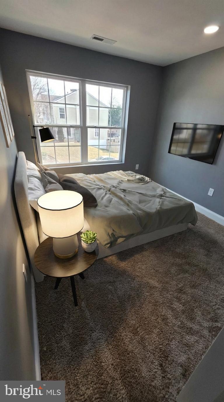 7544 Maury Road Windsor Mill, MD 21244 - Photo 12 of 14 a room with a bed and a chair