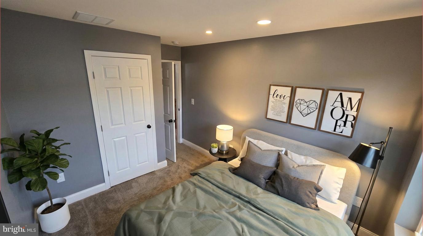 7544 Maury Road Windsor Mill, MD 21244 - Photo 13 of 14 a spacious bedroom with a bed and a potted plant