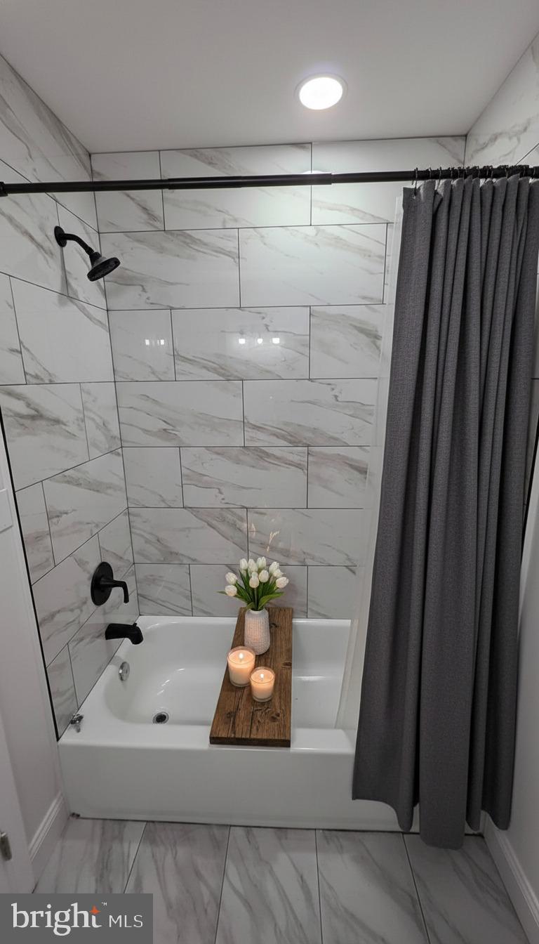 7544 Maury Road Windsor Mill, MD 21244 - Photo 7 of 14 a bathroom with a bathtub and shower