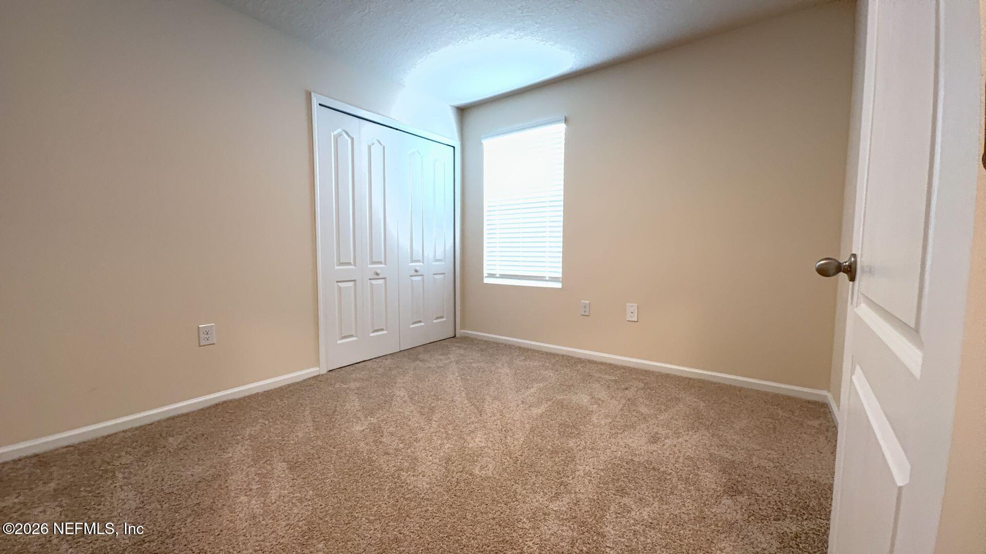 144 Redbud Road Palm Coast, FL 32137 - Photo 21 of 29 an empty room with windows