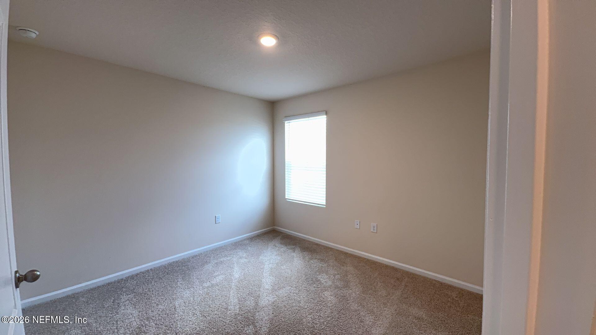 144 Redbud Road Palm Coast, FL 32137 - Photo 23 of 29 an empty room with a window