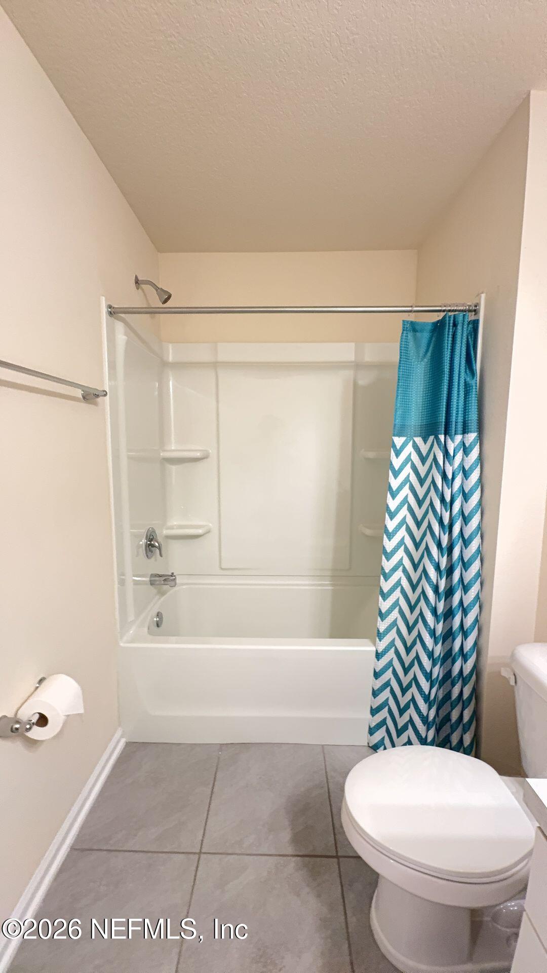 144 Redbud Road Palm Coast, FL 32137 - Photo 24 of 29 a bathroom with a toilet and a shower