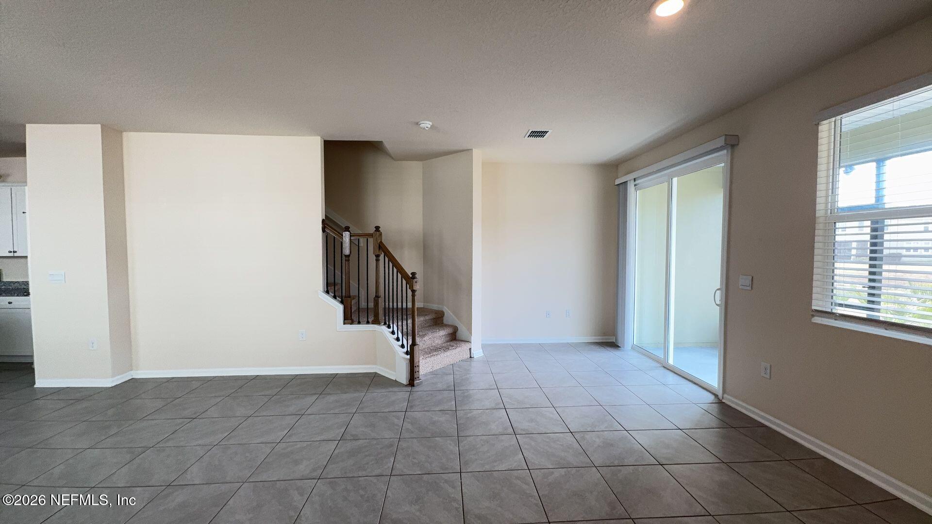 144 Redbud Road Palm Coast, FL 32137 - Photo 4 of 29 a view of an empty room with a window