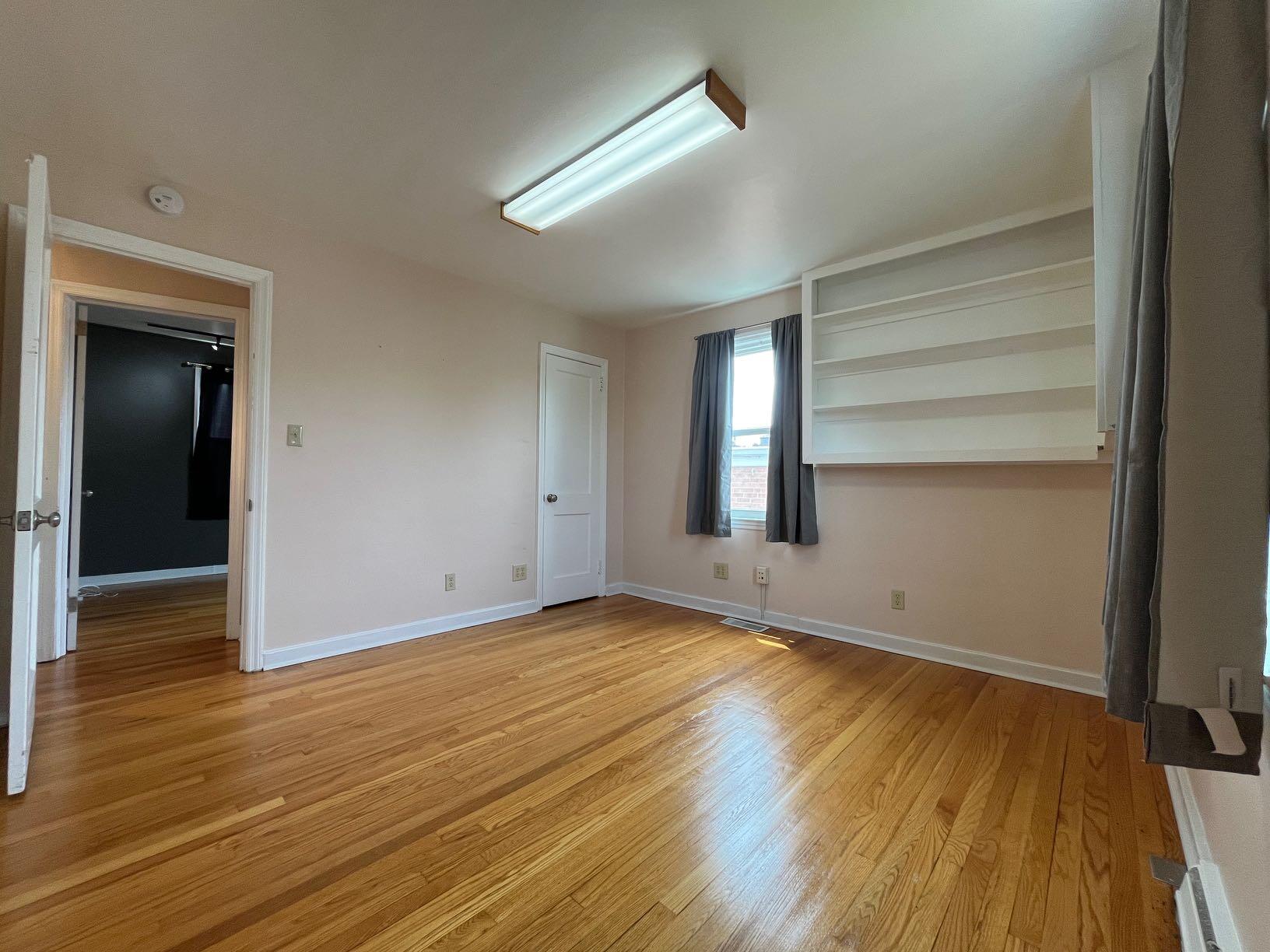 2610 Colonial Avenue Southwest Roanoke, VA 24015 - Photo 14 of 15 a view of an empty room with wooden floor and a window