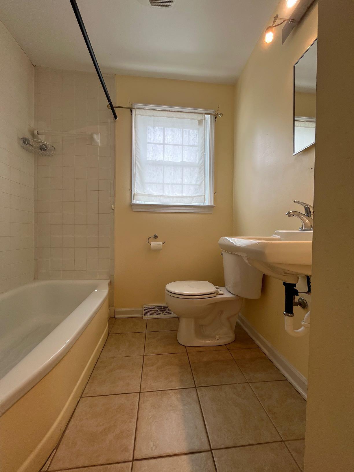 2610 Colonial Avenue Southwest Roanoke, VA 24015 - Photo 15 of 15 a bathroom with a sink a toilet and bathtub
