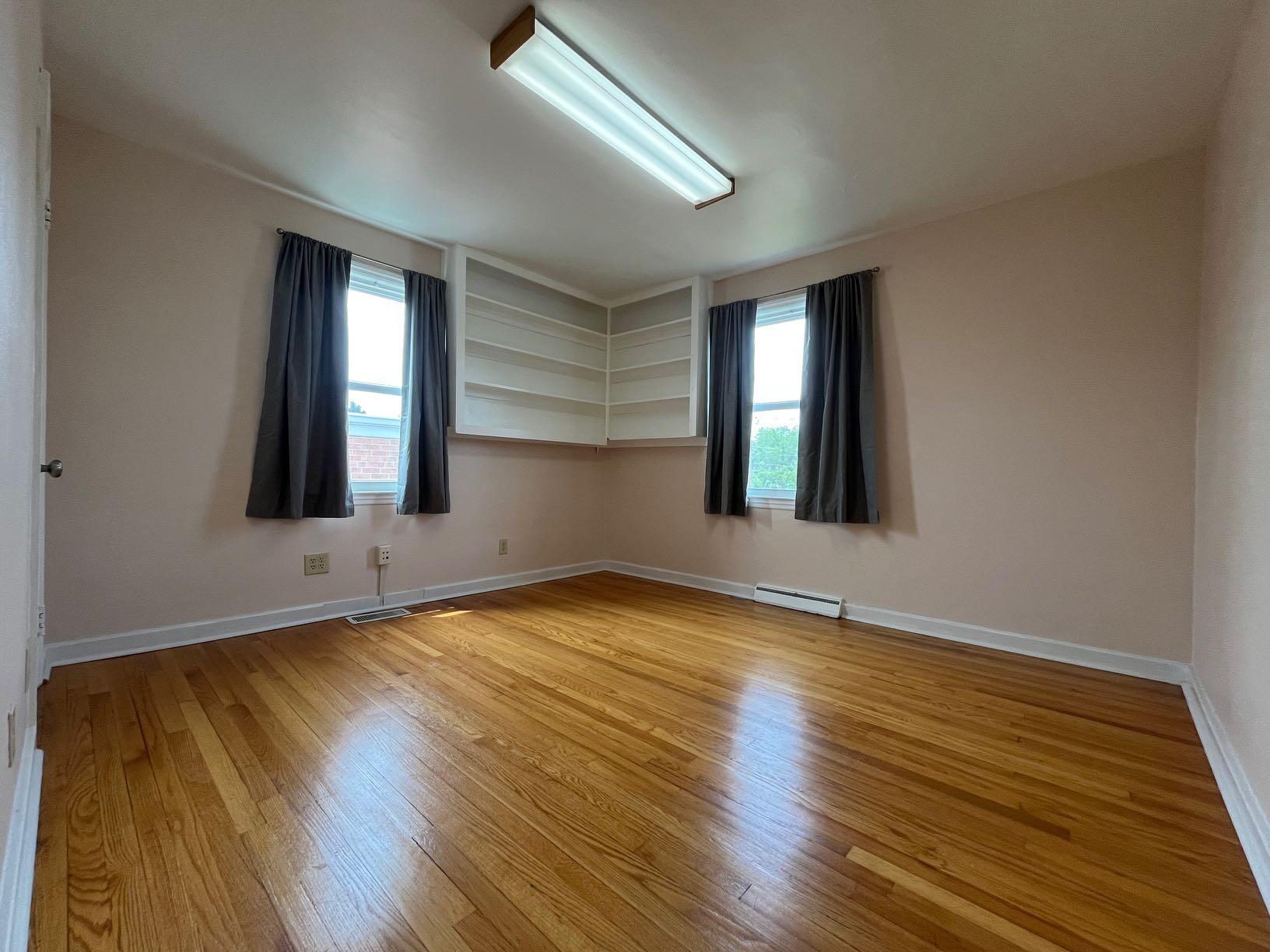 2610 Colonial Avenue Southwest Roanoke, VA 24015 - Photo 7 of 15 a view of an empty room with wooden floor and a window