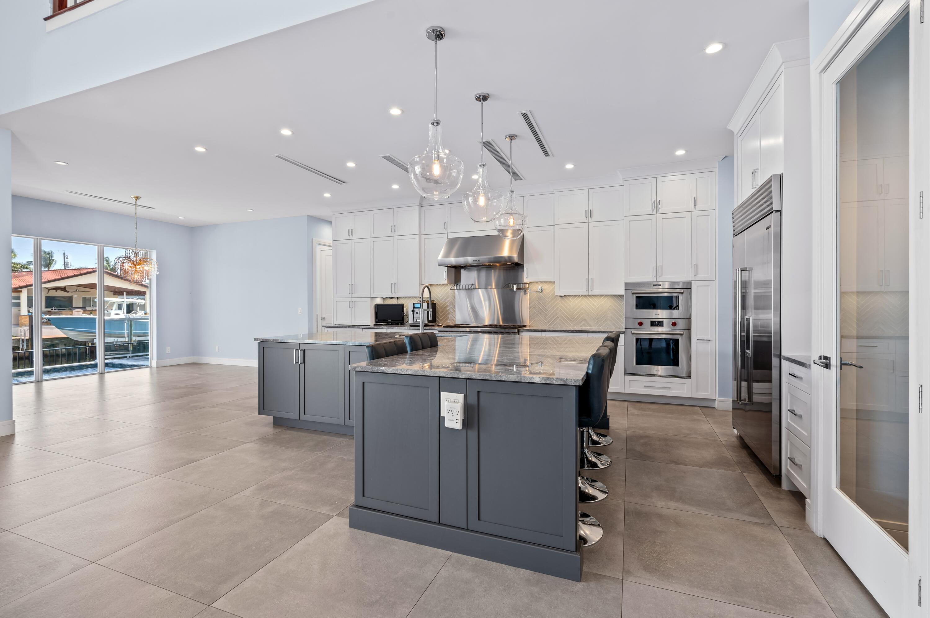 807 Dover Street Boca Raton, FL 33487 - Photo 9 of 43 a kitchen with counter top space cabinets and stainless steel appliances