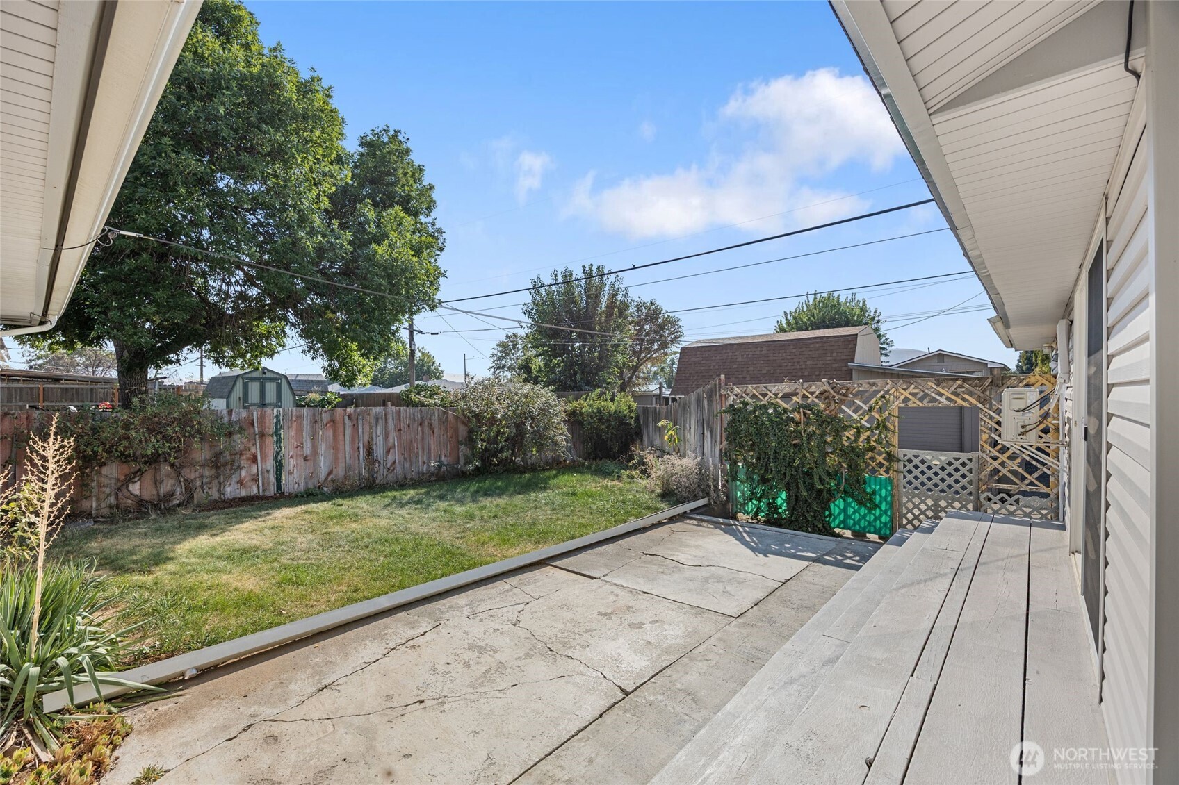 247 Northeast Ivy Ephrata, WA 98823 - Photo 11 of 40 a view of a backyard with potted plants and wooden fence