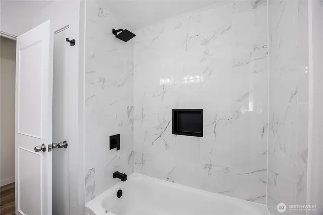 a bathroom with a bathtub and a shower