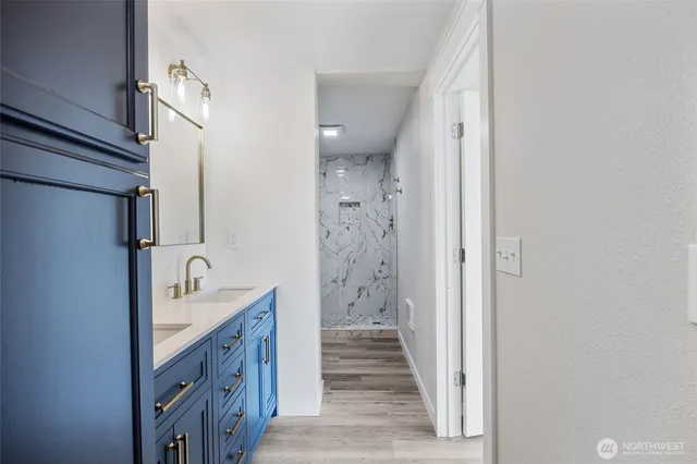 a bathroom with a sink a mirror and shower