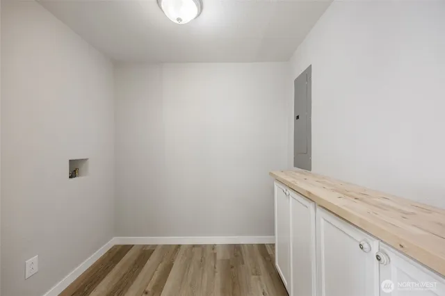 a view of a room with wooden floor