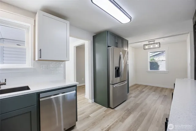 a kitchen with a refrigerator cabinet and a sink