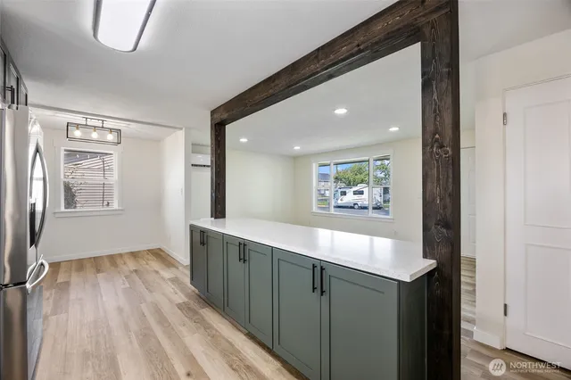 a view of kitchen with a sink wooden floor and a window
