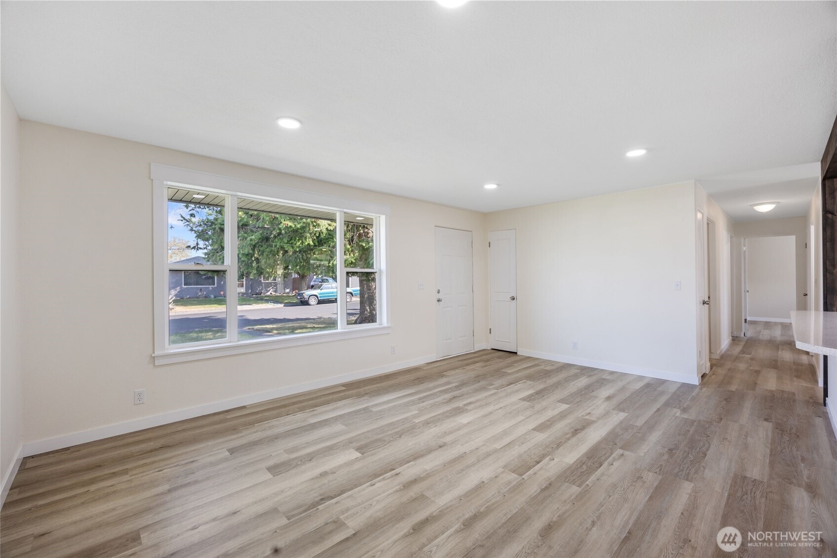 247 Northeast Ivy Ephrata, WA 98823 - Photo 33 of 40 a view of an empty room with wooden floor and a window