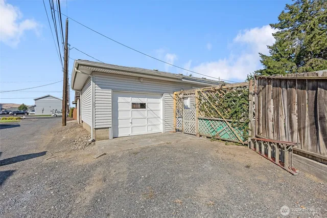 a view of a garage with wooden fence