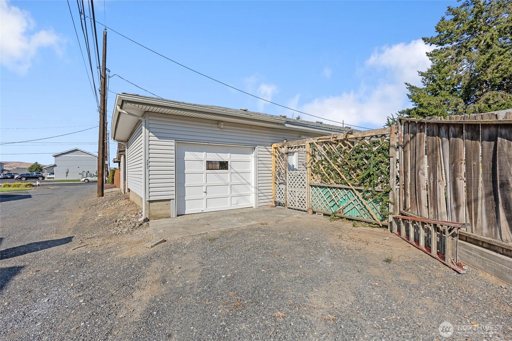 247 Northeast Ivy Ephrata, WA 98823 - Photo 7 of 40 a view of a garage with wooden fence